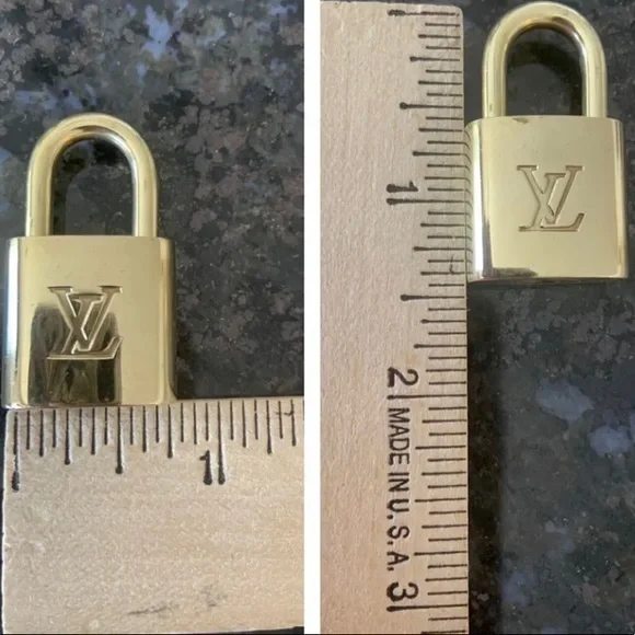 NEAR MINT Louis Vuitton lock and key set.
